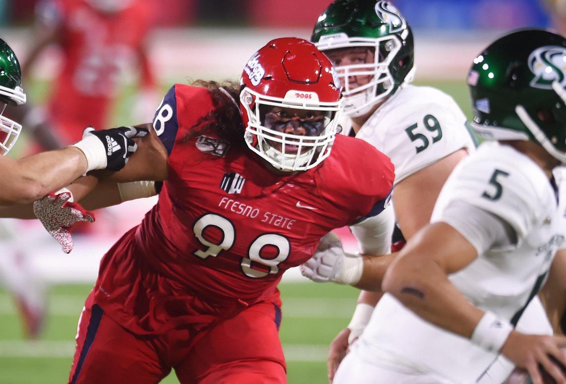 Fresno State’s Keiti Iakopo, center, rushes Sacramento State’s quarterbackKevin Thomson, right, Saturday, Sept 21, 2019 in Fresno.
