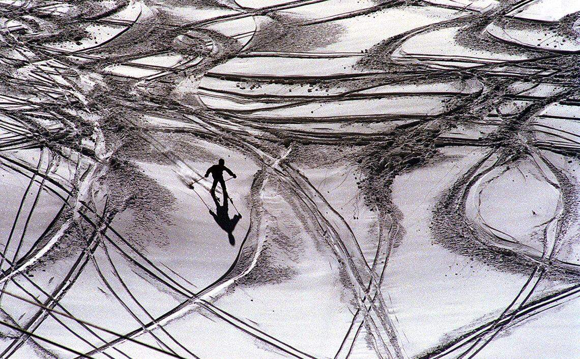 A solitary skier flies down a powdery slope at Badger Pass ski area in Yosemite National Park on Jan. 21, 1998.