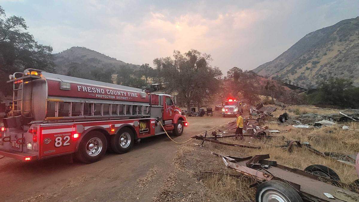 Cal Fire trucks are seen Sunday, Aug. 15, 2021, in the Squaw Valley area of Fresno County after a fire broke out in dry grass and oak woodland. Nearly 40 acres had burned as of early Sunday night.