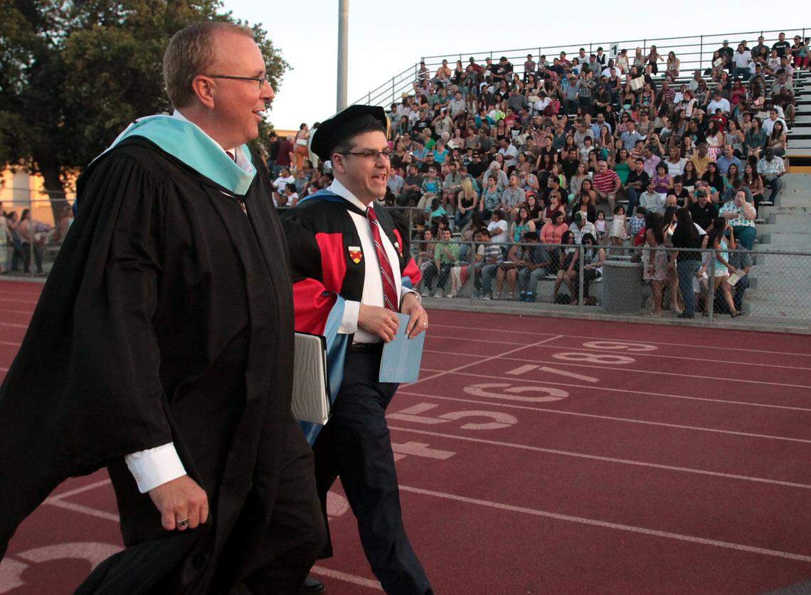 Hanford High School Principal Scott Pickle and recently-appointed president at California State University, Fresno Joseph Castro enter the stadium at Hanford High School before the commencement ceremony in Hanford on June 3, 2013. Castro is alumni of Hanford High School.