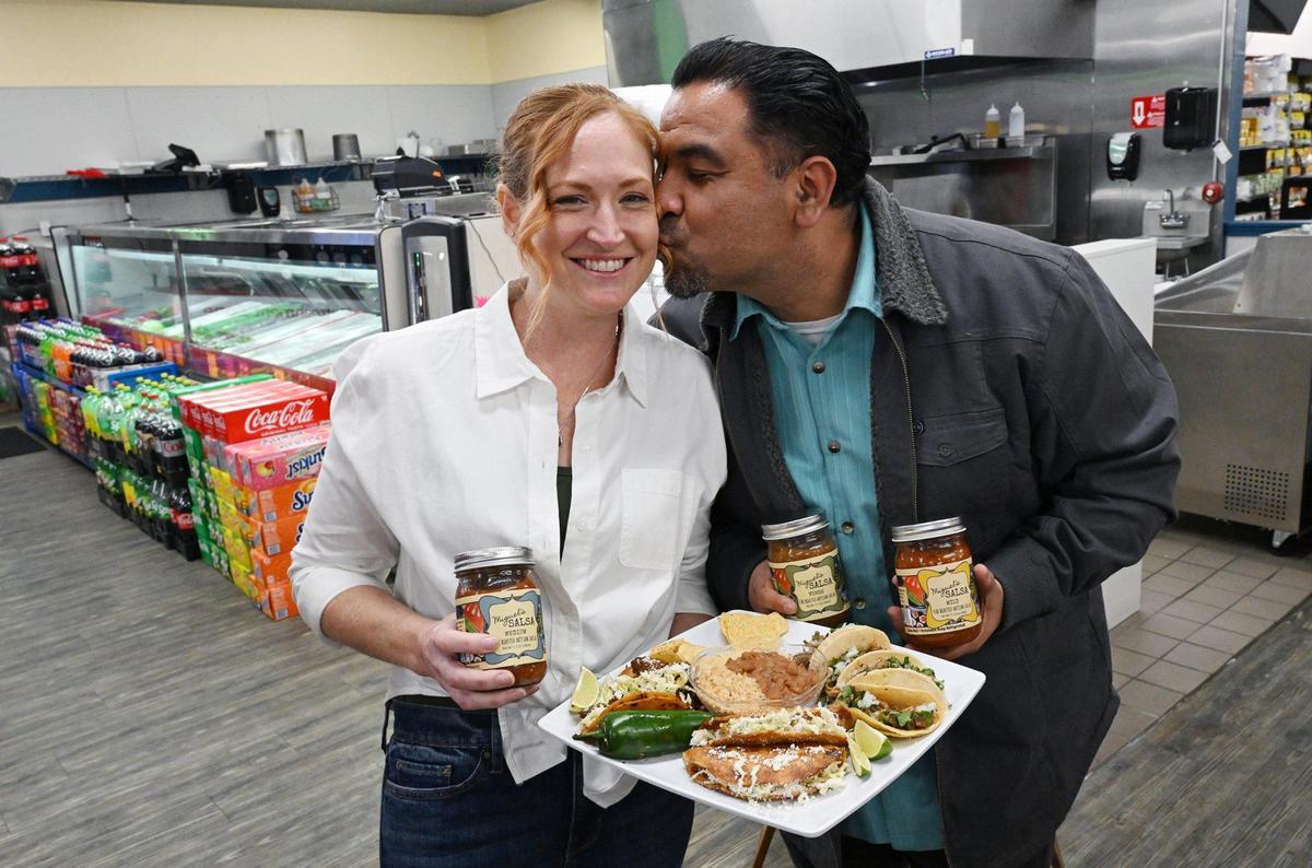 Miguel kisses his wife Lisa Segura at the couple’s first taqueria featuring Jalisco-inspired food and the couple’s new salsa collection.
