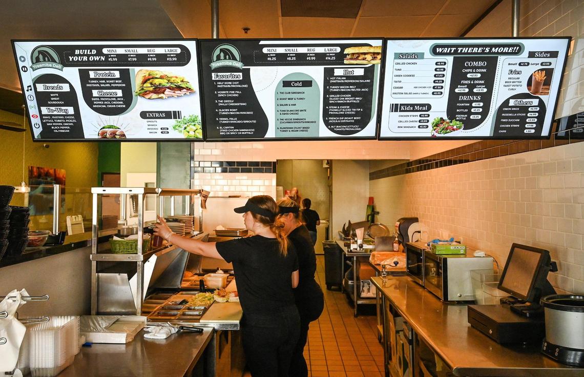 Employees work at Yosemite Deli which recently opened next to Starbucks on Milburn near Herndon in Fresno on Tuesday, July 26, 0222. The sandwich shop was formerly a Deli Delicious that has a Yosemite theme.