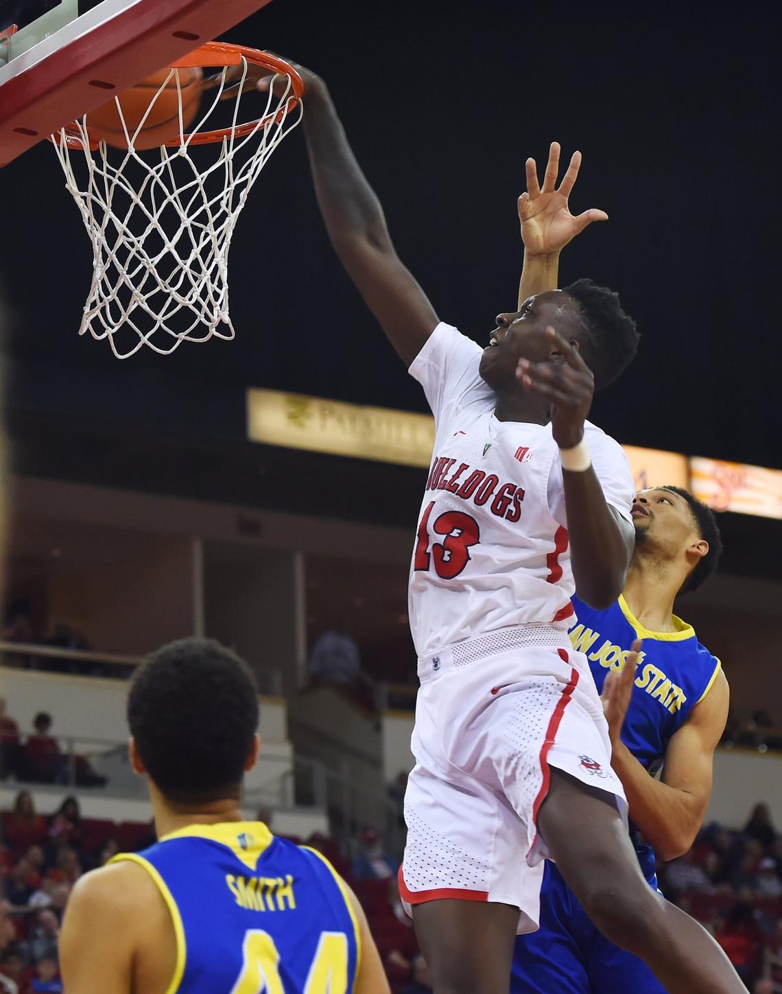 Fresno State guard Aguir Agau, left, dunks the ball while defended by San Jose State’s Zach Chappell in the Bulldogs’ 121-81 victory, Saturday, March 9, 2019 in Fresno. The Bulldogs finished the regular season 22-8, 13-5 in the Mountain West and have a No, 3 seed at the conference tournament.