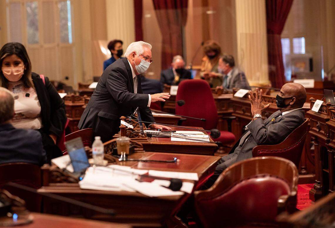 State Sen. Bob Archuleta, left, D-Pico Rivera, talks with Sen. Steven Bradford, D-Gardena, during a break on the last day of the California Legislature’s 2021 legislative session at the Capitol on Friday, Sept. 10, 2021, in Sacramento.