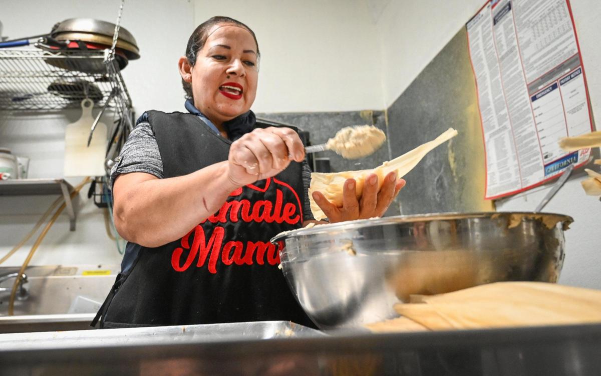Cristina Leon, the face of Tamale Mama, prepares tamales in the kitchen of her new restaurant in Fresno’s Chinatown area on Wednesday, March 1, 2023.