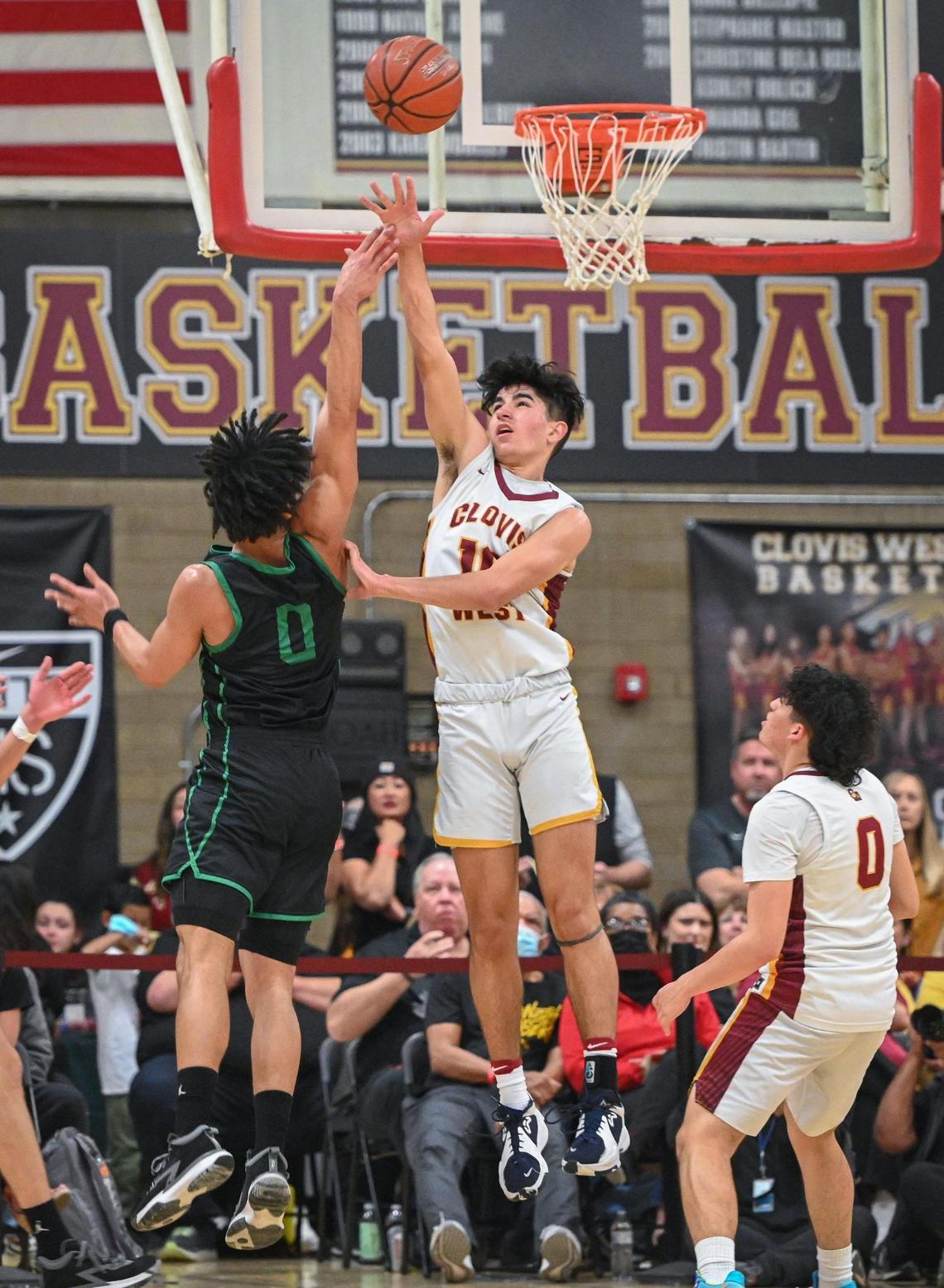 Clovis West’s Zach Chauhan, right, tries to block a shot by St. Joseph’s Dre Roman during their Central Section Open Division championship game at Clovis West on Saturday, Feb. 26, 2022.