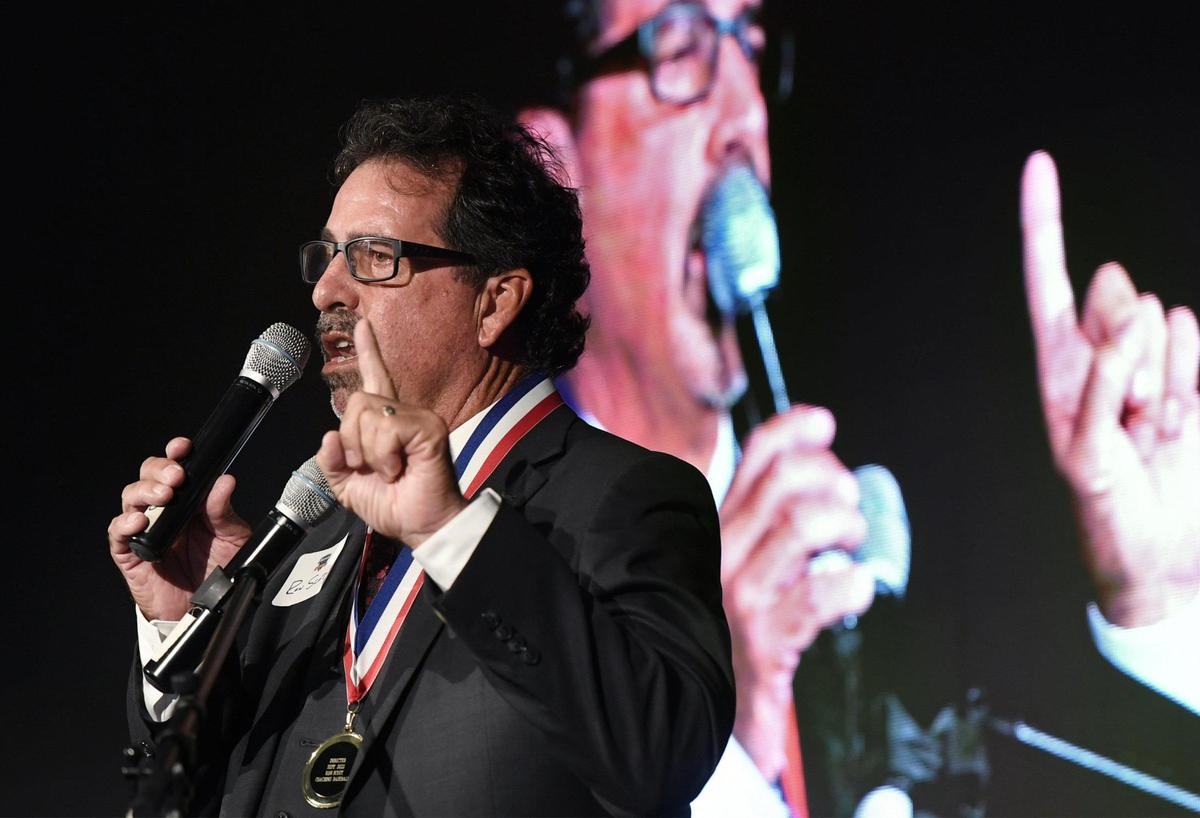2022 inductee Fresno City College baseball coach Ron Scott jokingly points out he has a new suit for the event as he thanks his supporters at the 63rd Annual Fresno County Athletic Hall of Fame Enshrinement Night Wednesday, Sept. 21, 2022 in Fresno. The event was also the grand opening for the Athletic Hall of Fame’s new location inside the Save Mart Center at Fresno State.