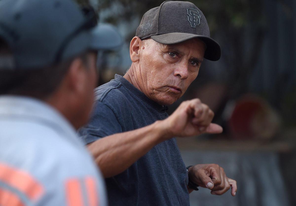 Ricardo Valenzuela, right, talks about water supply issues in the community of West Park, with Amador Valenzuela standing to the left Thursday, Oct. 3, 2019 west of Fresno.