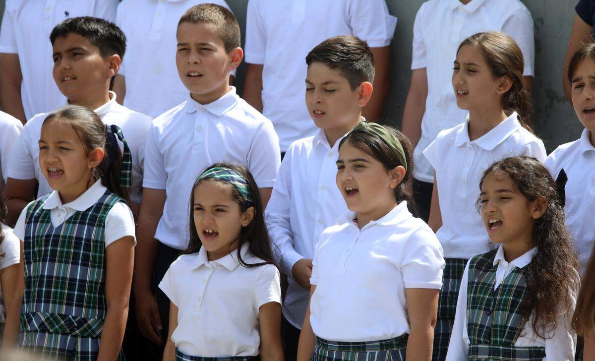 Students from the Charlie Keyan Armenian Community School in Clovis sing during the annual Armenian genocide commemoration and flag-raising ceremony at Fresno City Hall on April 24, 2025.