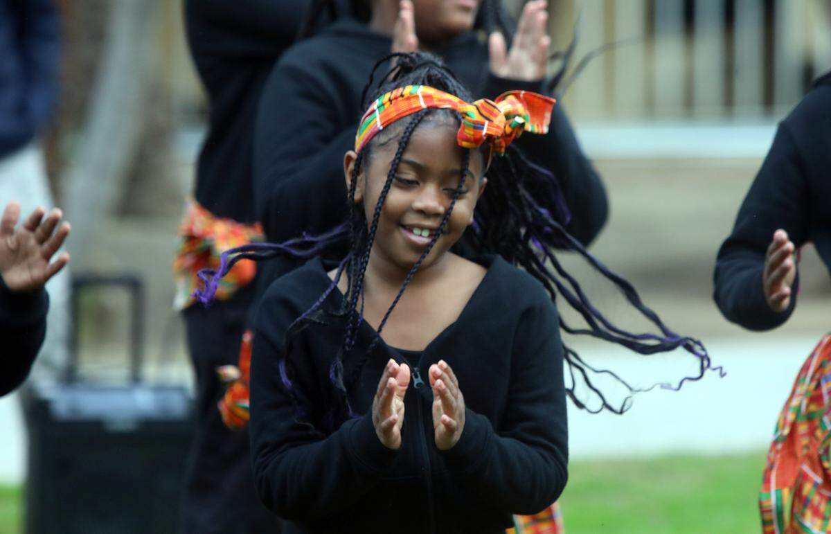 A student from Martin Luther King Jr. Elementary School dances during a garlanding ceremony at Courthouse Park in Fresno.