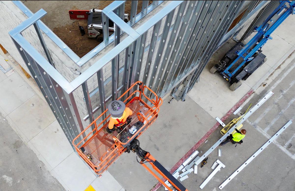 Two new businesses have signed leases for the former Walmart on West Shaw Avenue as construction workers work on the sprawling structure near Brawley Avenue.