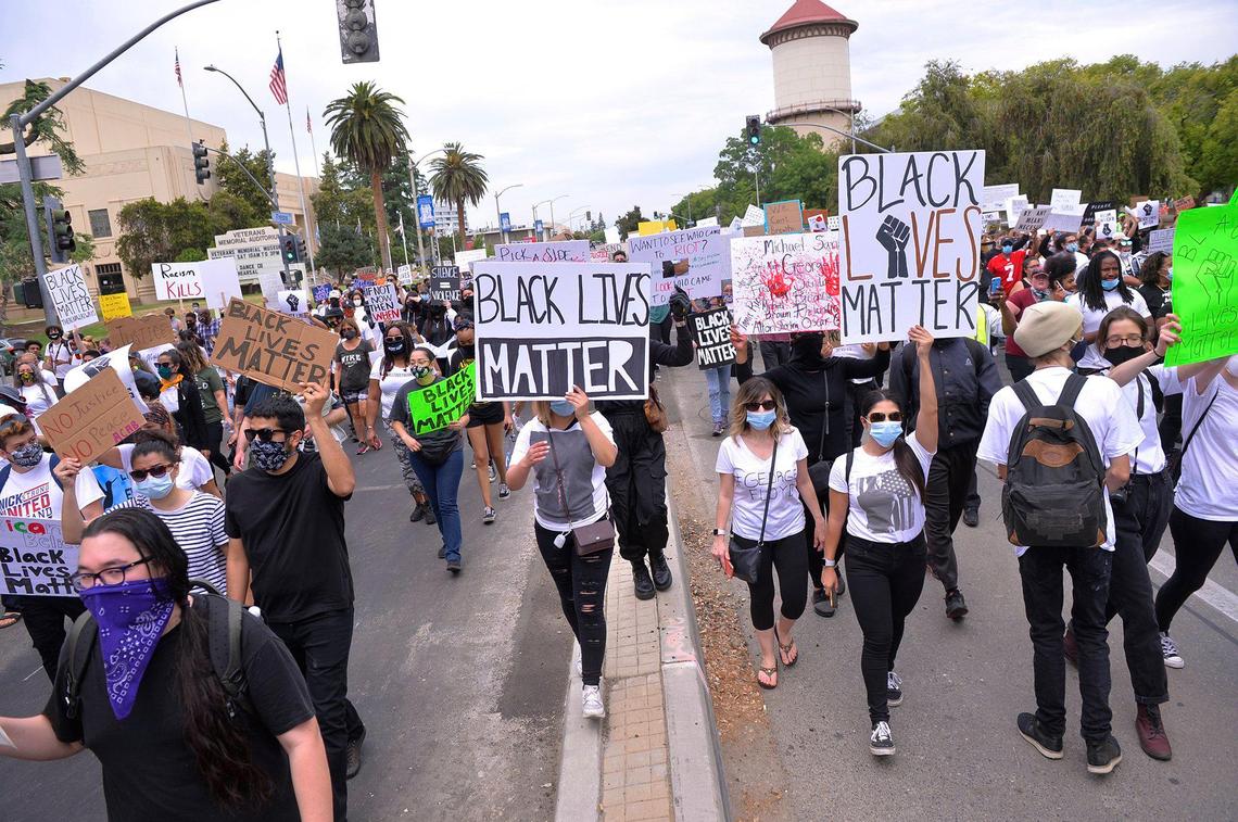 Marchers proceed west along Fresno Street during a Sunday, May 31, 2020, protest over the death of George Floyd.