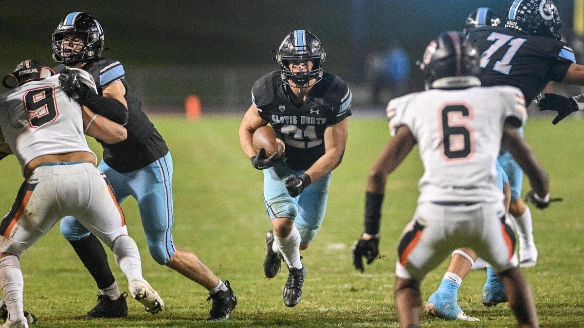 Clovis North’s Jackson Cinfel, center, runs up the middle against Central during their Tri-River Athletic Conference football final at Veterans Memorial Stadium on Thursday, Oct. 26, 2023.