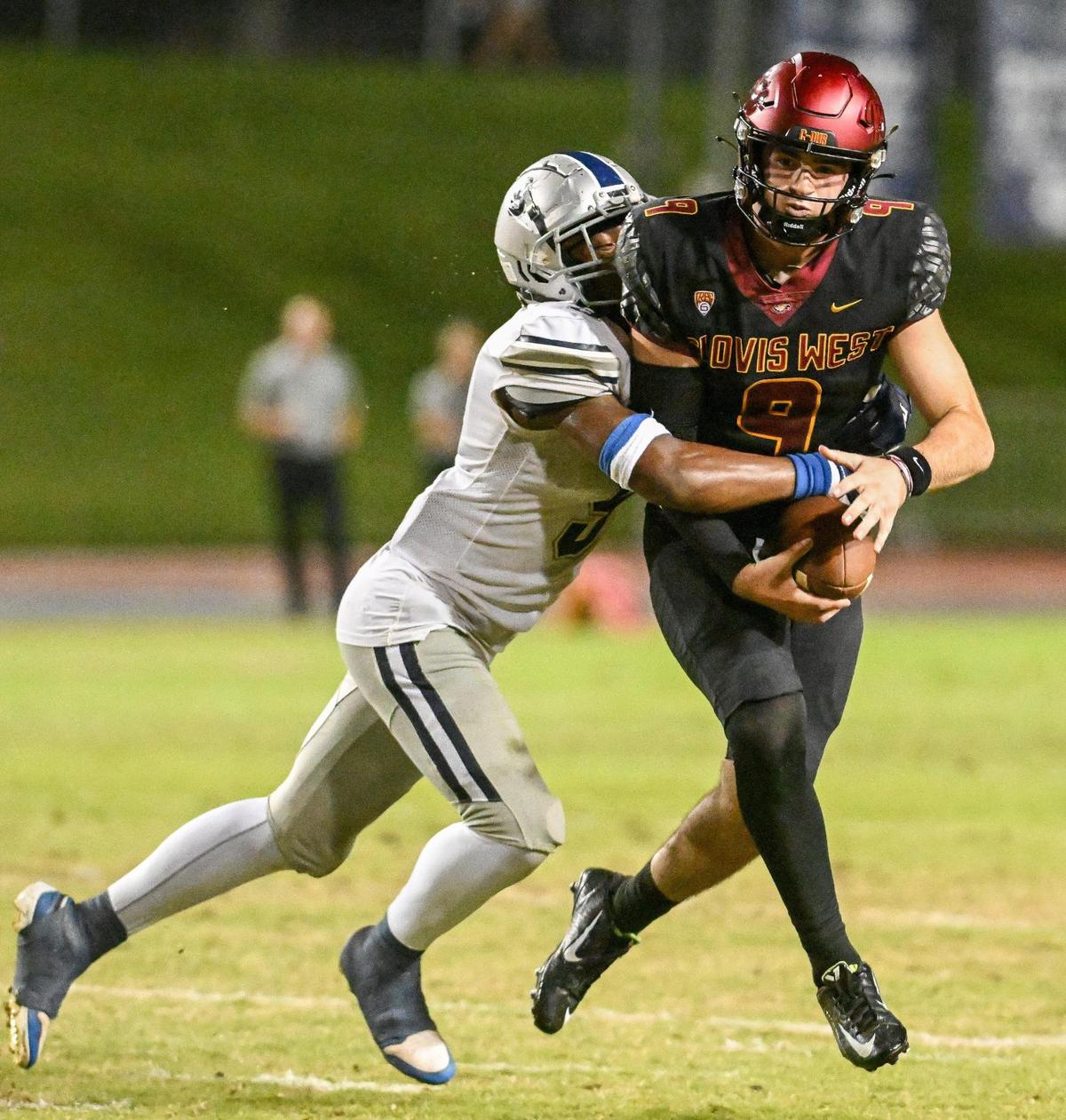 Clovis East’s Nathaniel Thompson wraps up Clovis West quarterback Tyler Patrick for the sack during their game at Veterans Memorial Stadium in Clovis on Friday, Oct. 6, 2023.