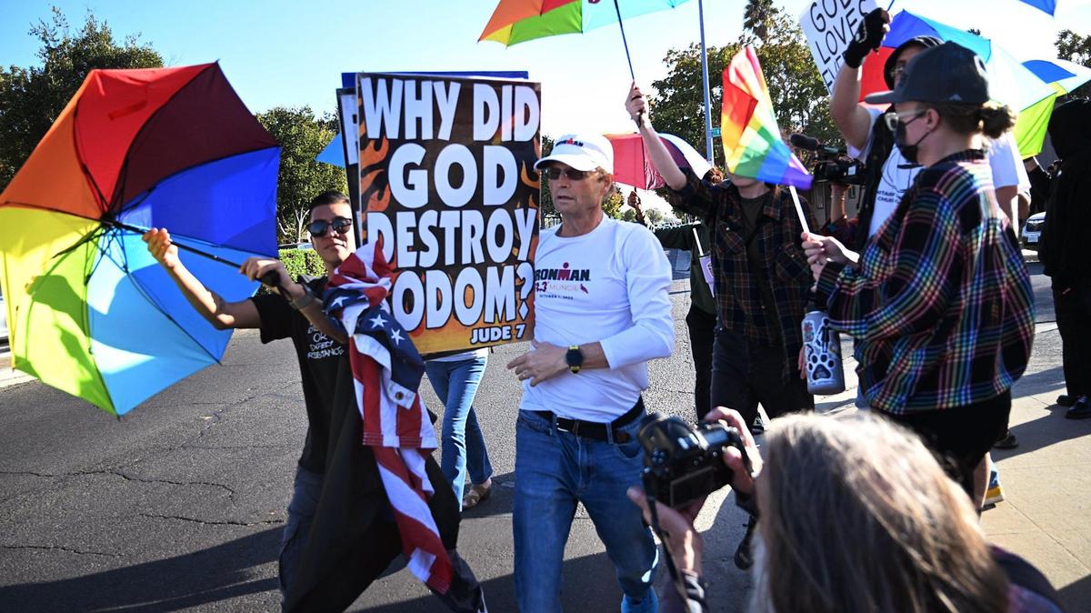 A supporter of the anti-LGBTQ Westboro Baptist Church of Topeka is surrounded by counter-demonstrators while protesting in Fresno, Calif. last October.