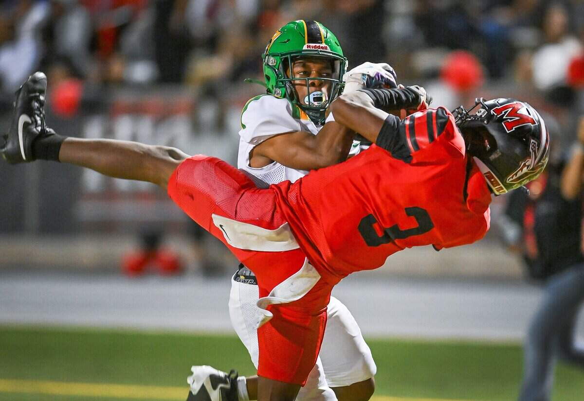 McLane's Julyen Scott, right, wrestles the football away from Roosevelt's Dupree Evans for a Highlanders touchdown catch in the end zone during their North Yosemite League showdown at McLane Stadium on Thursday, Oct. 9, 2025.