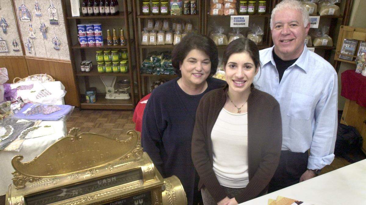 Owners of Hye Quality Bakery, Sammy and Paula Ganimian, with daughter Joy Aller, stand in the bakery’s storefront in this file photo from 2003.