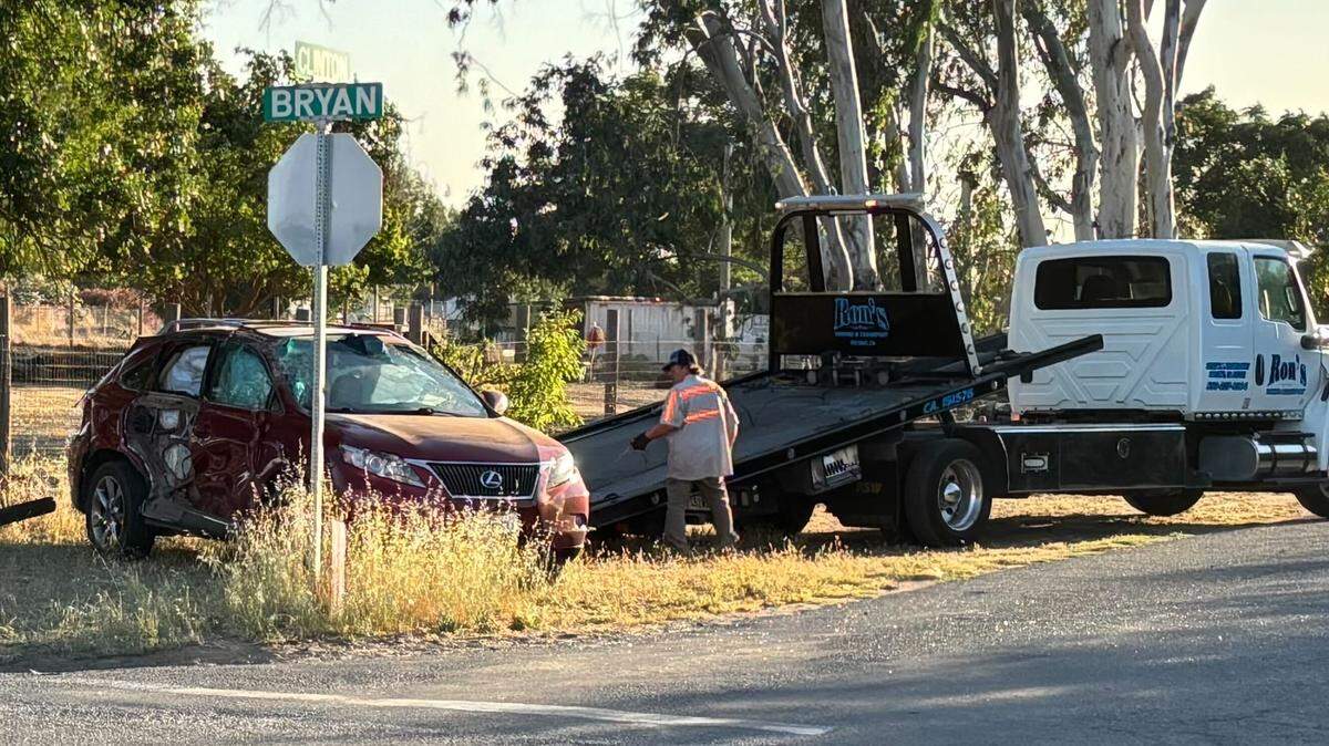A tow truck driver gets ready to haul a red Lexus onto his flatbed on Friday, May 15, 2026.