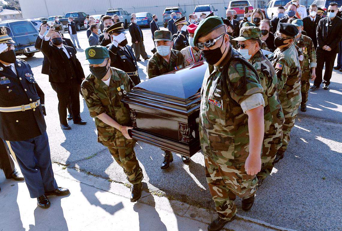 The casket carrying Col. Wangyee Vang, Ph.D is carried into the Faith Community Religious Facility by a special U.S. Secret Army Hmong veterans’ honor guard on the first of the three-day memorial service Saturday morning, March 13, 2021 in Fresno, California. Vang was the leader of the National Lao Hmong veterans group and served in the US Secret Army during the Vietnam War.