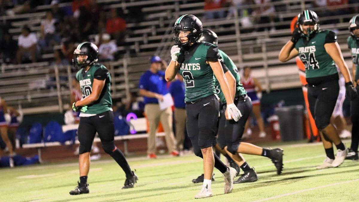Reedley High’s Malachi Rios, middle, during a game against Firebaugh on Friday, Aug. 18, 2023.
