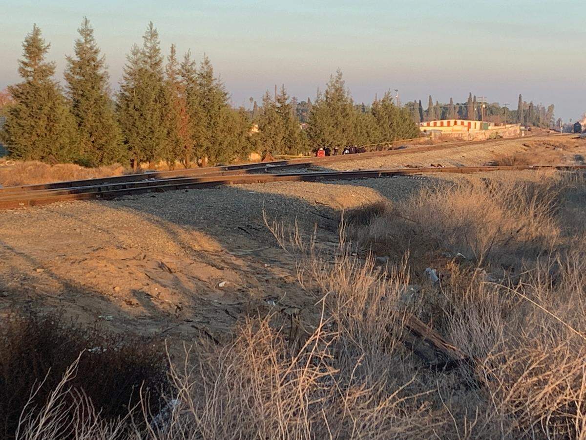 Investigators were on the scene of a fire that broke out at what is believed to have been a makeshift shelter along the railroad tracks near Belmont and Marks avenues in Fresno, California. Flames spread and one person died.