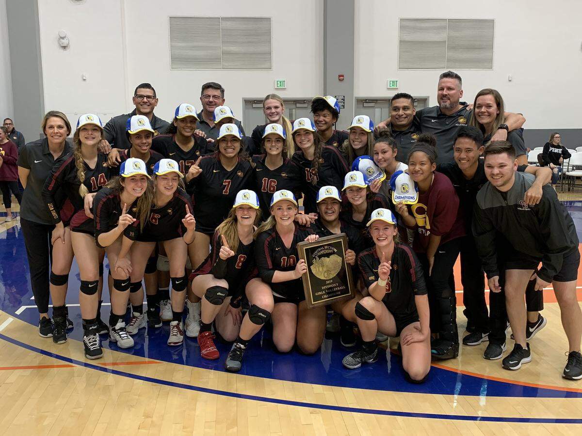 The Clovis West High girls volleyball team celebrates its Central Section Division I championship after beating Liberty-Bakersfield in five sets in the final Saturday night at College of the Sequoias.