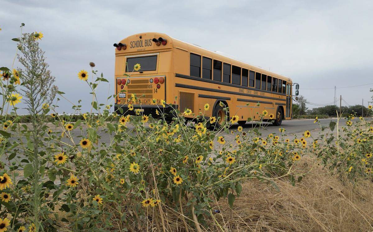 An Orange Center School Dustrict bus passes a field along S Cherry Avenue Thursday, Sept. 18, 2025 south of Fresno. The Fresno City Council will decide whether to annex and rezone an area along South Cherry Avenue between E North Ave. and E Central Ave to allow increased trucking traffic but people who live in those rural areas and administrators at the Orange Center School District oppose the change. Photographed Thursday, Sept. 18, 2025 in Fresno