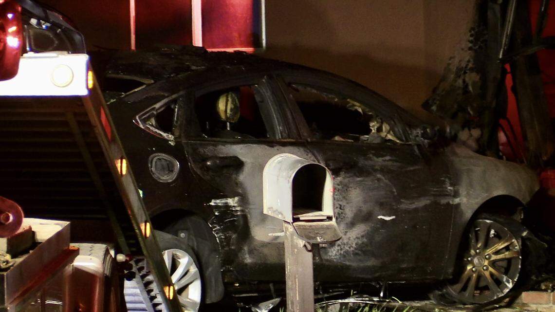A vehicle is charred after it crashed into a garage of a Clovis, California home on Tuesday, Aug. 22, 2023.