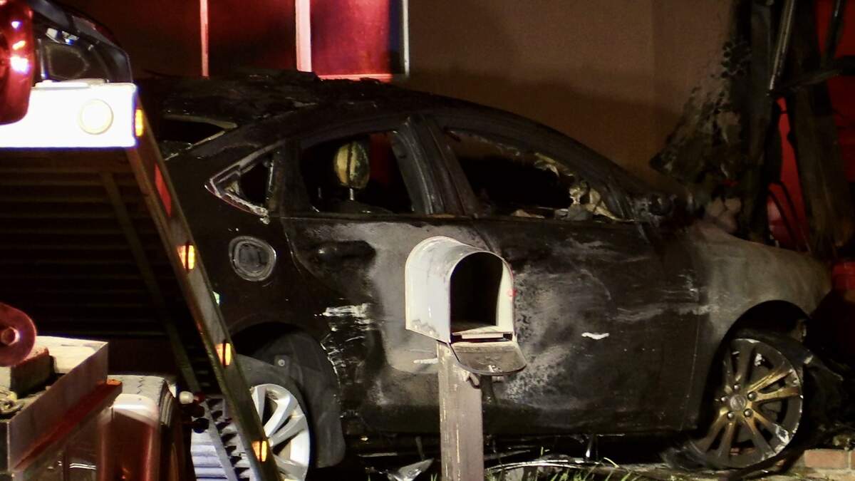 A vehicle is charred after it crashed into a garage of a Clovis, California home on Tuesday, Aug. 22, 2023.