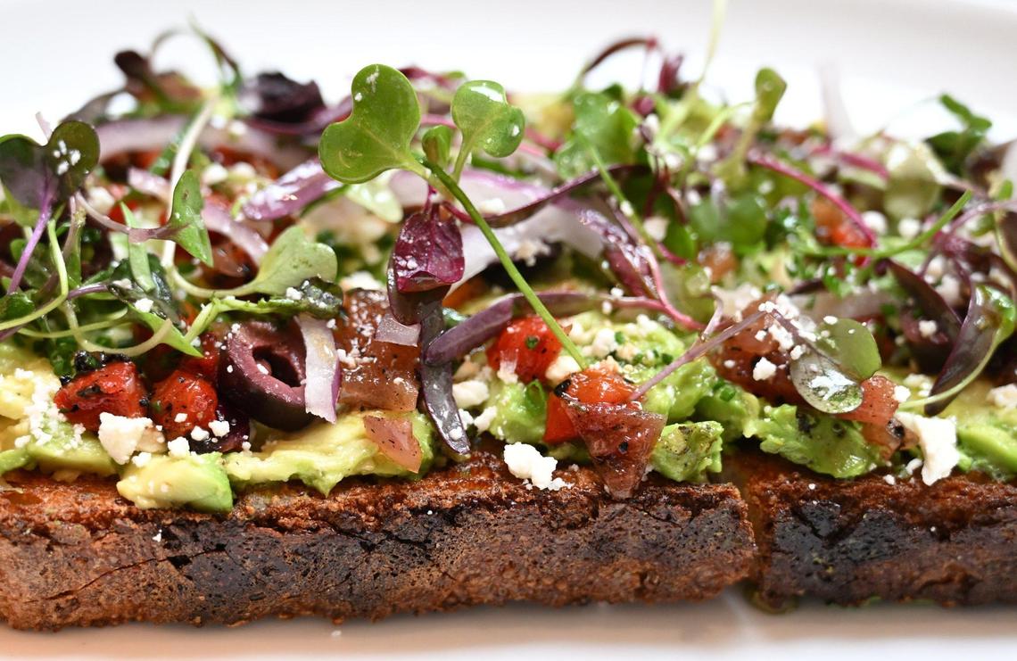Avocado toast on rustic bread with Hass avocado, roasted sunflower seeds, lemon, olive oil, a red wine-vinegar herb mix and Maldon salt is a popular item at Otherside Cafe in northeast Fresno.