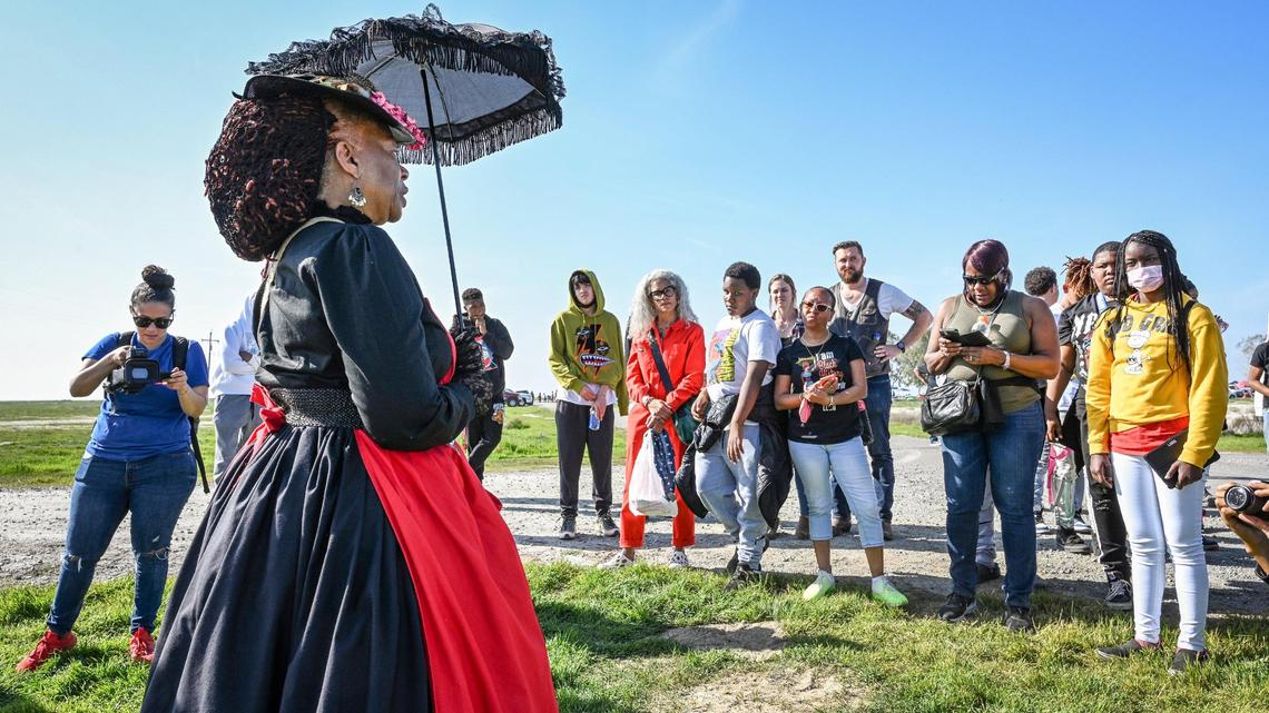 Gale Harris, dressed in early 20th century attire, talks to visitors about life for African Americans when Allensworth was a thriving town, during the 46th Annual Black History Festival at Colonel Allensworth State Historic Park in southwest Tulare County on Saturday, Feb. 12, 2022.