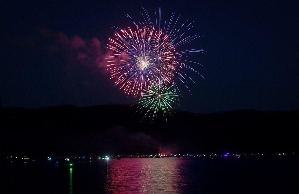 Fireworks burst in a colorful display over the lights of dozens of boats on Shaver Lake, July 3, 2021. The annual event drew hundreds to the lake, after a year-long hiatus due to Covid and the Creek Fire, to celebrate the 4th of July holiday.