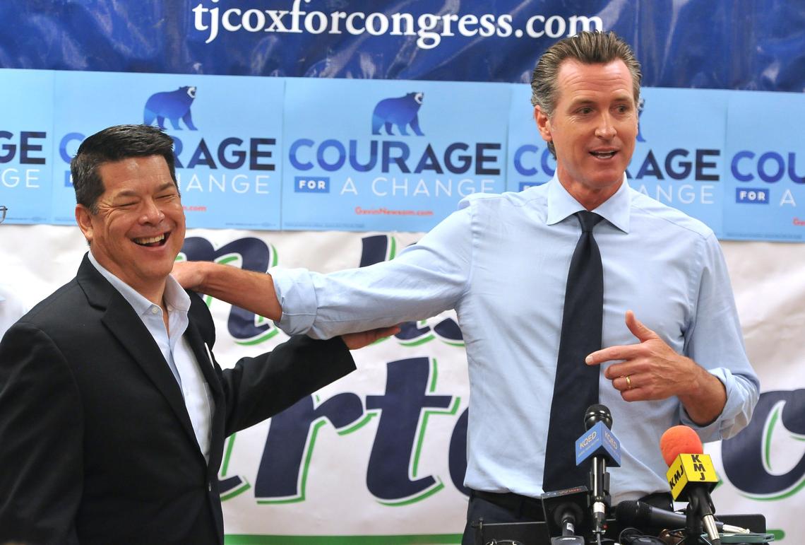 Lt. Gov. Gavin Newsom jokes with TJ Cox, Democratic candidate for Congress, left, during a campaign stop at the Fresno Democratic Headquarters last month. Newsom is running for governor.