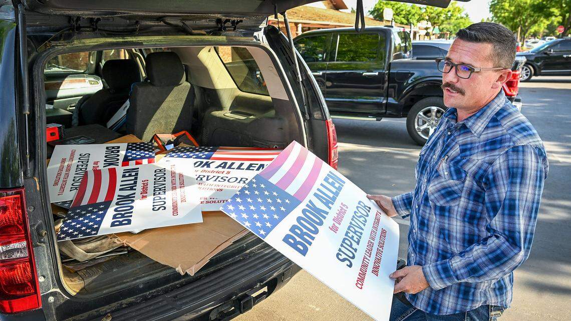 Brook Allen pulls signs out of the back of his vehicle following an interview about his campaign to run for District 5 Supervisor in Madera County on Wednesday, April 15, 2026.