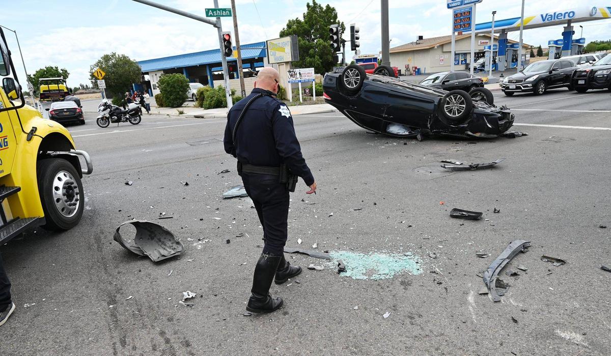 The scene of a three-vehicle collision including a rollover at the intersection of West Ashlan Avenue and Parkway Drive, Tuesday, April 19, 2022 in Fresno. Fresno Police spokesman Felipe Uribe said a vehicle ran a red light and collided with two other vehicles, with one ended up on its roof.