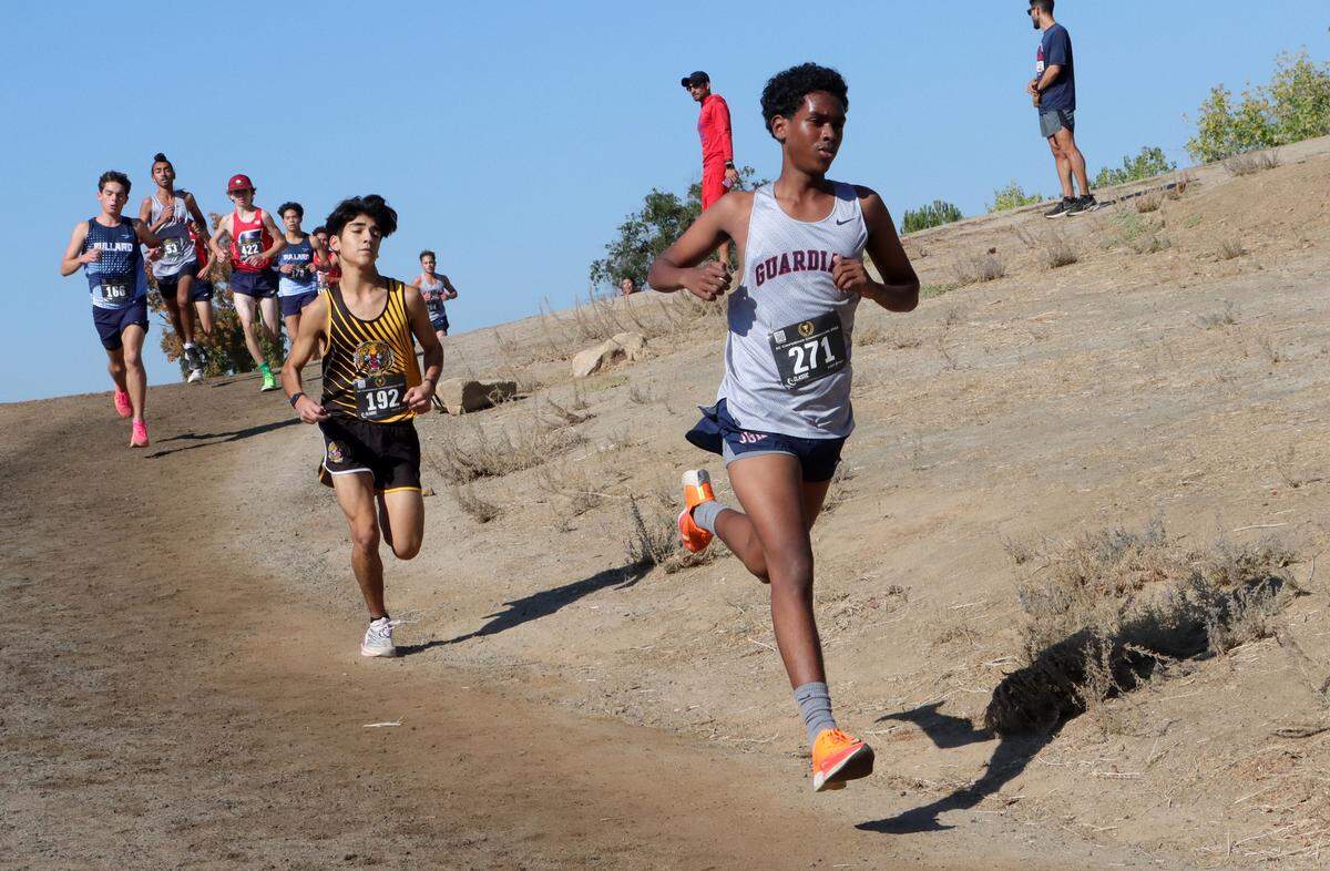 Justin Garza High senior Zelalem Teffra leads a pack of runners during the CMAC cross country championships at Woodward Park on Nov. 8, 2023.
