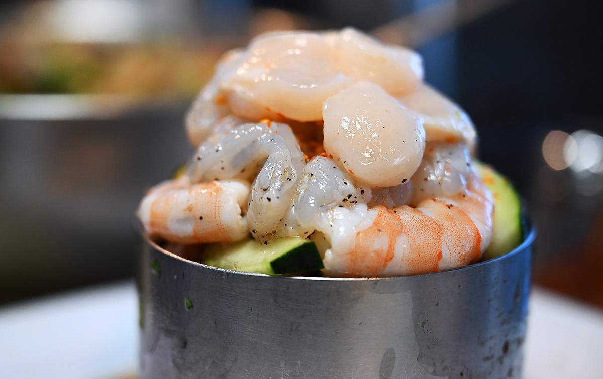 An El Botanero Torre begins to take shape with two types of shrimp and scallops at El Botenero Mariscos Wednesday, August 6, 2025 in Fresno.