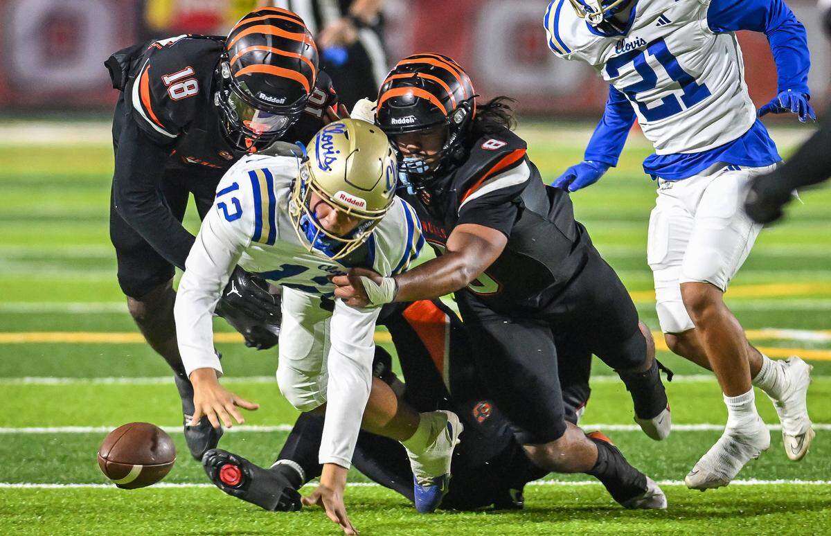 Clovis quarterback Deagan Rose loses the ball on a keeper but is able to maintain possession against Central East in their game at Koligian Stadium in Fresno on Friday, Oct. 24, 2025.