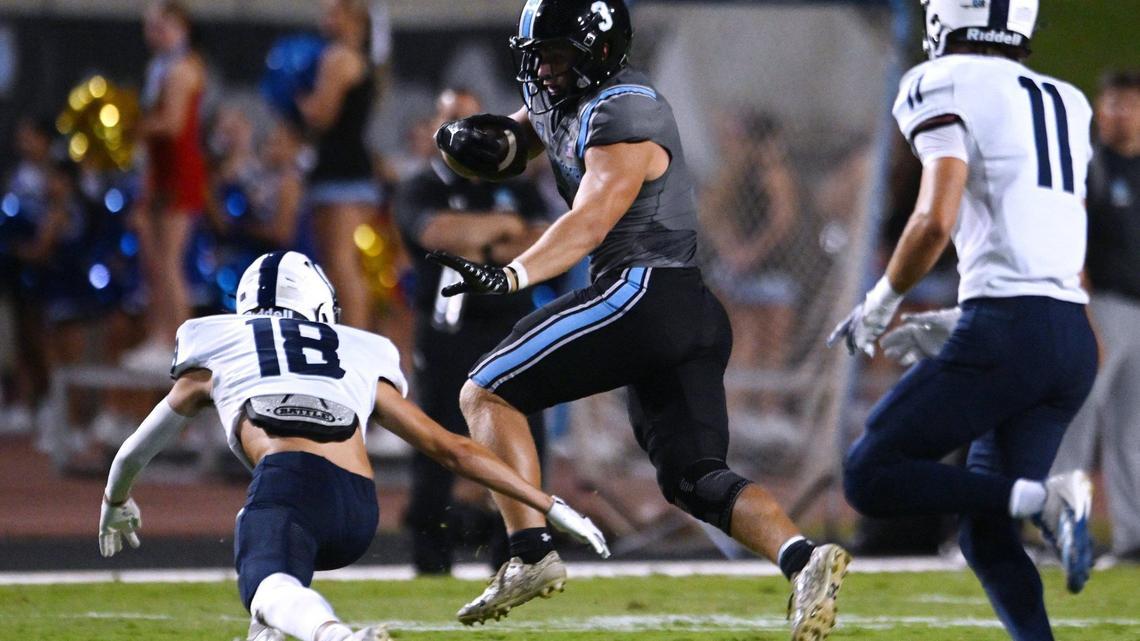 Clovis North’s McKay Madsen, right, runs past CVC’s Teague Brandenburg, left, in a game Friday, Sept. 13, 2024 in Clovis.