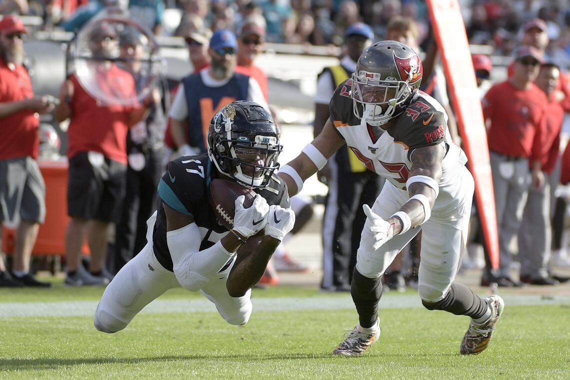Jacksonville Jaguars wide receiver D.J. Chark dives for a catch in front of Tampa Bay Buccaneers cornerback Carlton Davis during the second half of a game Sunday, Dec. 1, 2019.