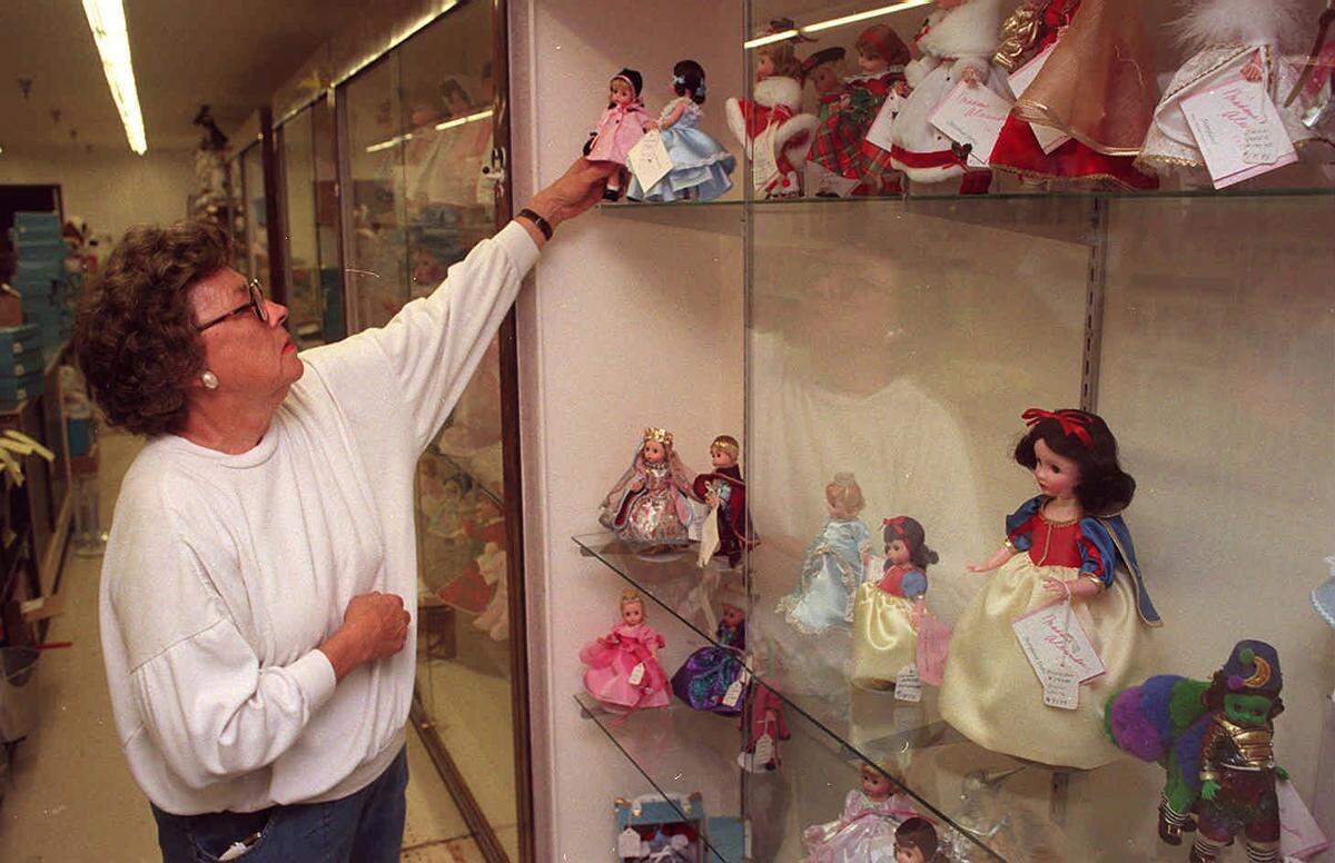 Lola Page of Arthur’s Toys arranges collectable dolls to prepare for the store's opening at its new location at Shields and Cedar avenues in this Fresno Bee file photo from 1995.