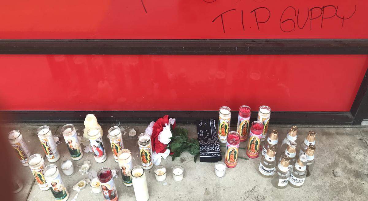 Candles and beer were left in front of the smoke shop where a fatal double shooting took place on Friday, Dec. 20, 2019.