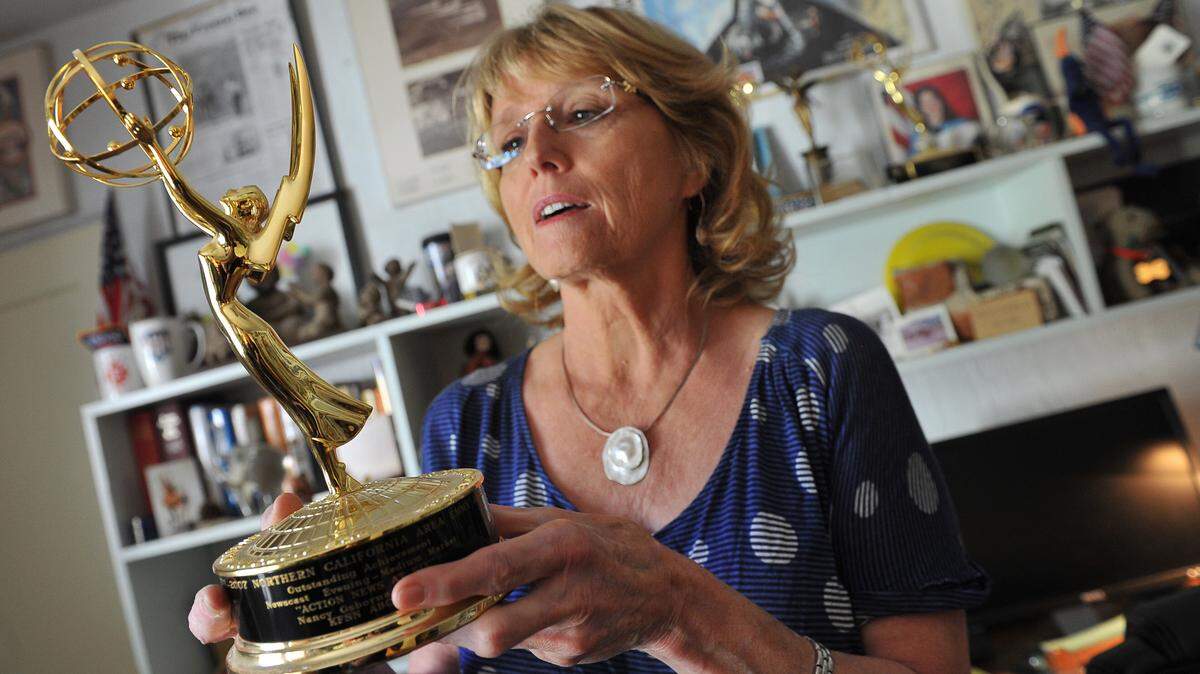 KFSN anchor Nancy Osborne holds one of her three regional Emmys in her home office in this Bee file photo from 2012 when she announced her retirement.