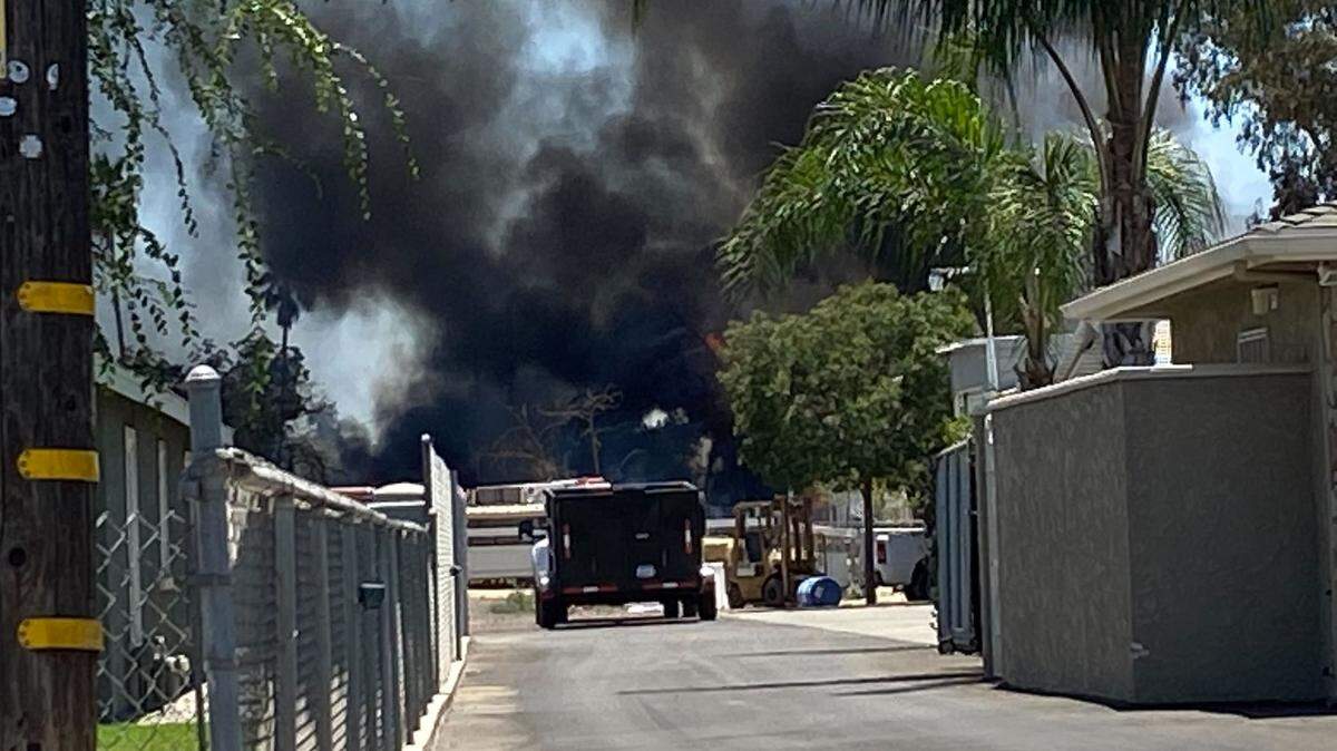 Black smoke wafts into the air near Belmont and Brawley avenues in Fresno, California, on Monday, July 11, 2022.