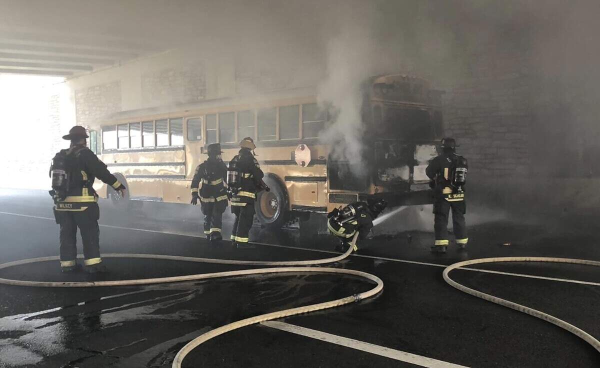 Firefighters mop up after a school bus caught on fire Friday, March 18, 2022, along El Dorado Hills Boulevard under Highway 50. All students from Buckeye Unified School District’s Valley View Charter School were safely evacuated.