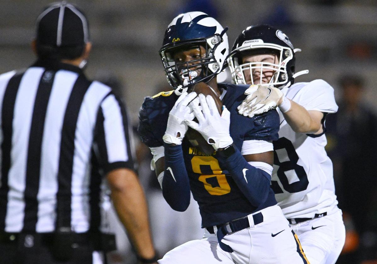 Sunnyside’s Jason Dixon, left, makes the catch covered by Redwood’s Thomas Plummer, right, in the Central Section D2 playoff game Friday, Nov. 3, 2023 in Fresno. Sunnyside led 12-7 at halftime.