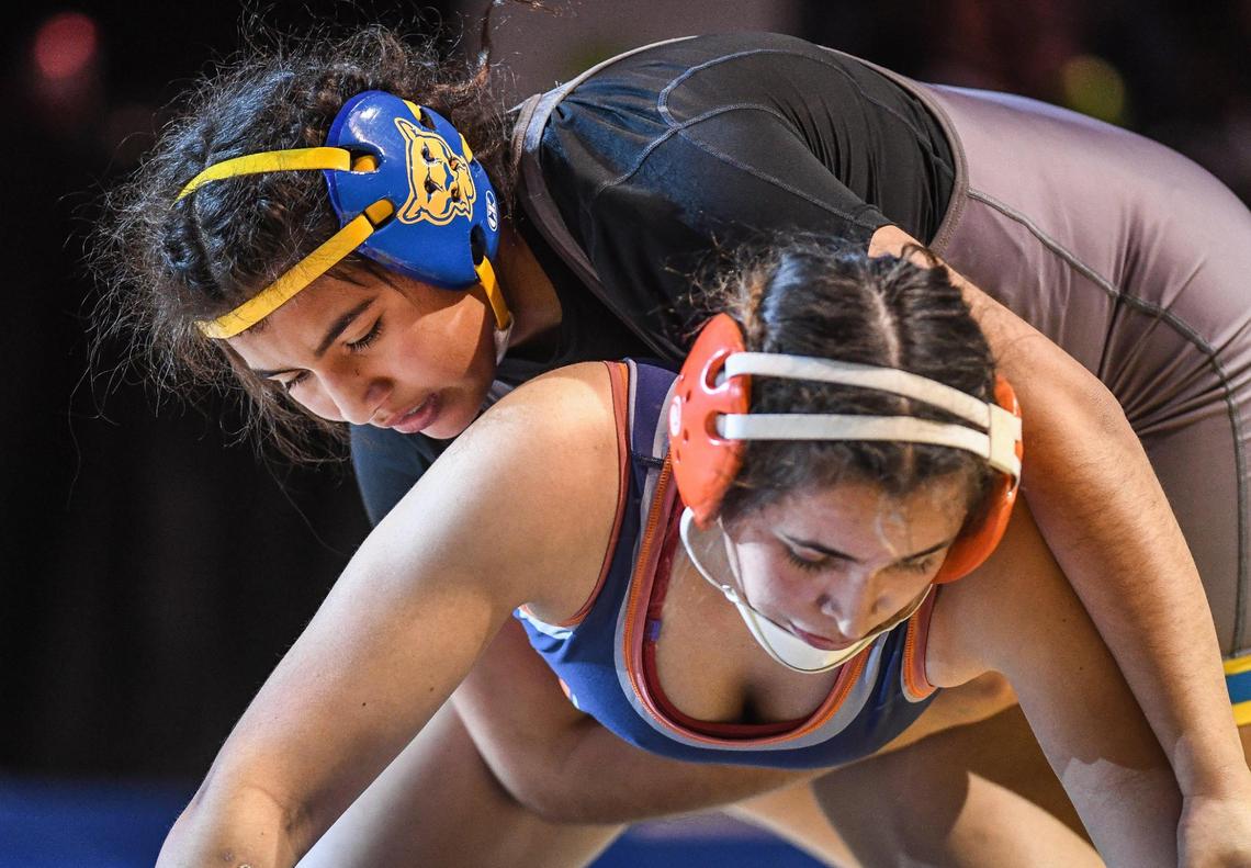 Clovis’ Leilani Lemus, top, wrestles Vida Beckel of Cypress in the girls 160-pound CIF State Wrestling Championship match at Mechanics Bank Arena in Bakersfield on Saturday, Feb. 25, 2023. Lemus defeated Beckel for the championship.