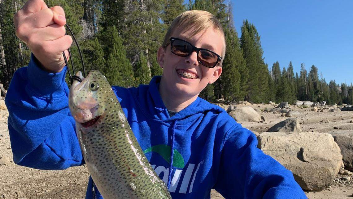 Noah Seim, 11, shows off an 18-inch trout caught from the bank at Courtright Reservoir about 8 a.m. Saturday. His father, Kenny Seim, says Noah used ann orange Berkley Gulp Alive set to 12 inches from the bottom. Dad wryly notes, “When we landed it, the lake dropped a few inches.”