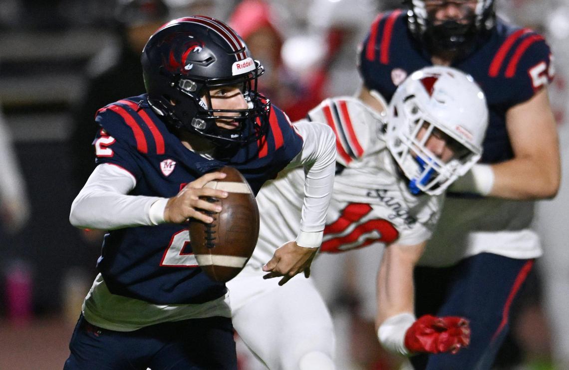 San Joaquin Memorial quarterback Colton Johnson, left, is chased by Sanger’s Cody Coles, right, Friday, Nov. 1, 2024 in Fresno. Sanger beat Memorial 59-21.