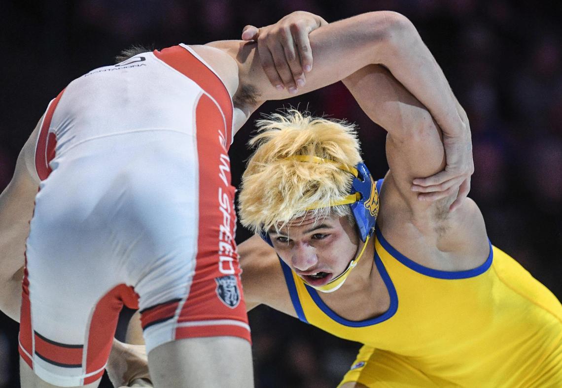 Clovis’ Dario Lemus, right, wrestles Brock Mantanona in the boys 138-pound CIF State Wrestling Championship match at Mechanics Bank Arena in Bakersfield on Saturday, Feb. 25, 2023. Lemus defeated Mantanona and won the state championship.